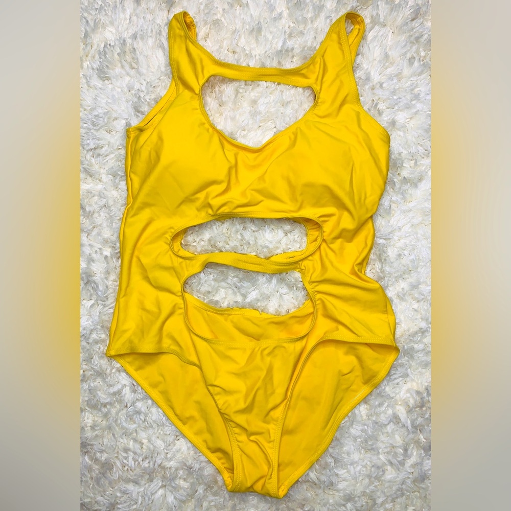 Yellow one piece swimsuit with cut outs. Size Large.